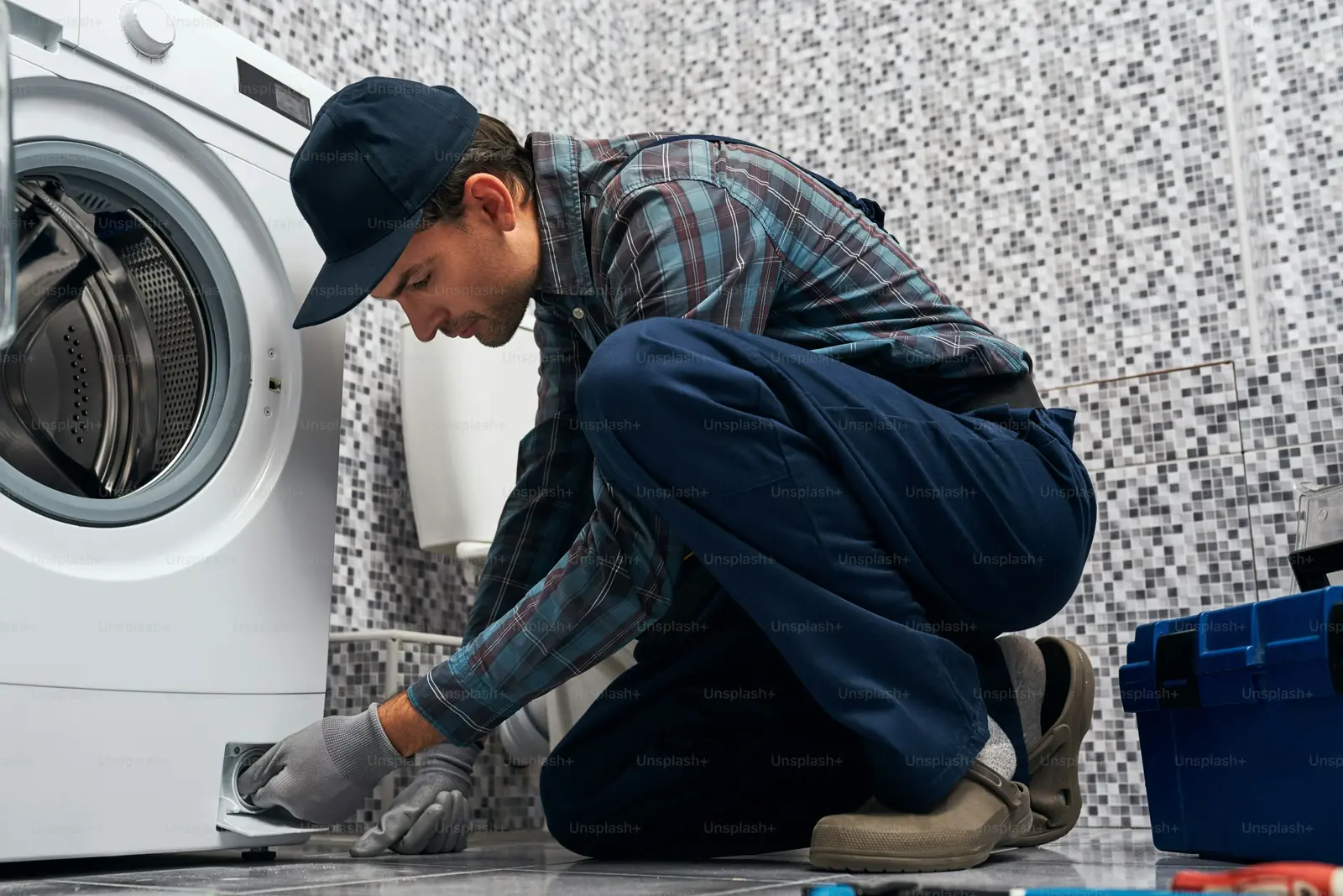 Appliance technician repairing a machine
